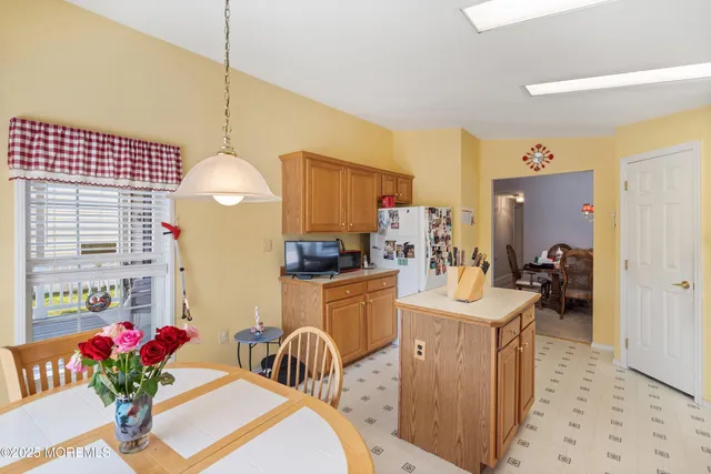 a kitchen that has a lot of cabinets and stainless steel appliances