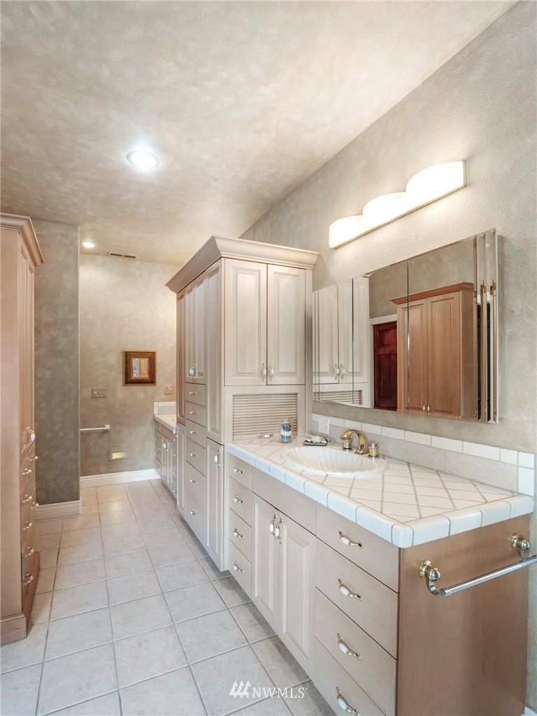 2599 Seminary Hill Road Centralia, WA 98531 - Photo 21 of 29 a spacious bathroom with a double vanity sink a mirror and a shower