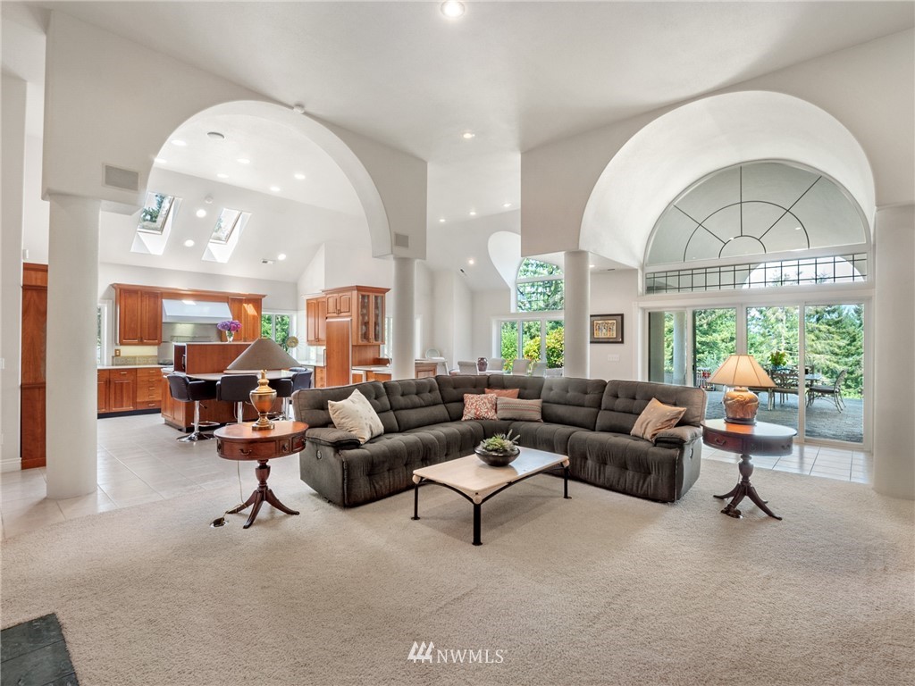 2599 Seminary Hill Road Centralia, WA 98531 - Photo 5 of 29 a living room with furniture a chandelier and a large window