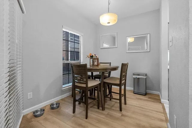 a view of a dining room with furniture and a window