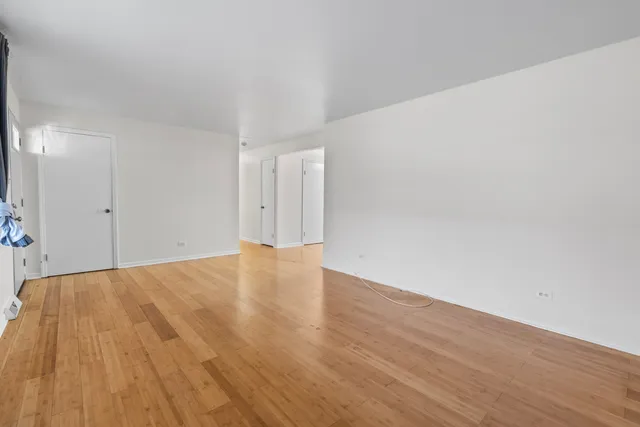 a view of an empty room and wooden floor