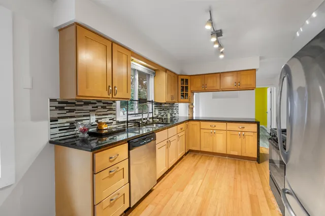 a kitchen with stainless steel appliances a stove sink and cabinets
