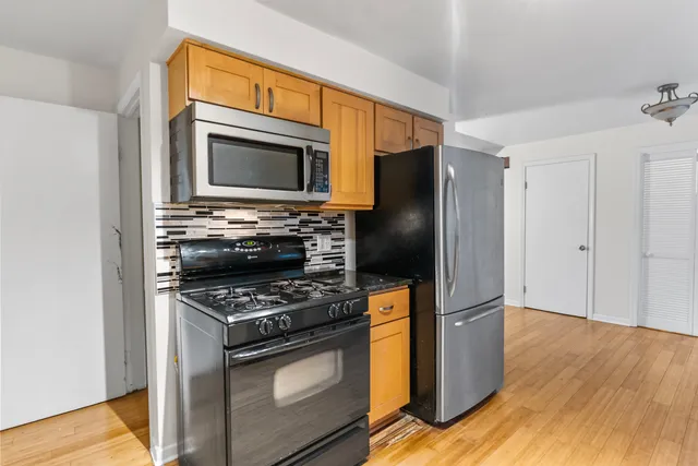 a kitchen with granite countertop a stove and a microwave
