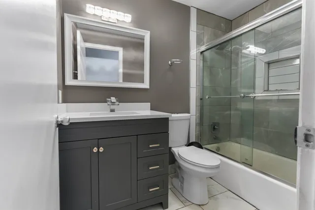 a bathroom with a sink toilet and shower