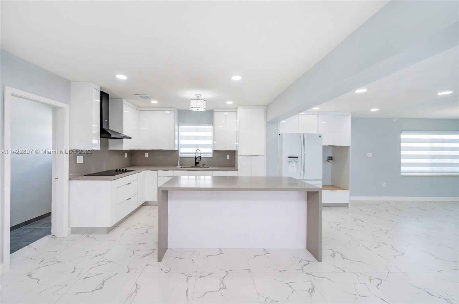 79 West 37th Street Hialeah, FL 33012 - Photo 3 of 28 a large kitchen with cabinets and counter space