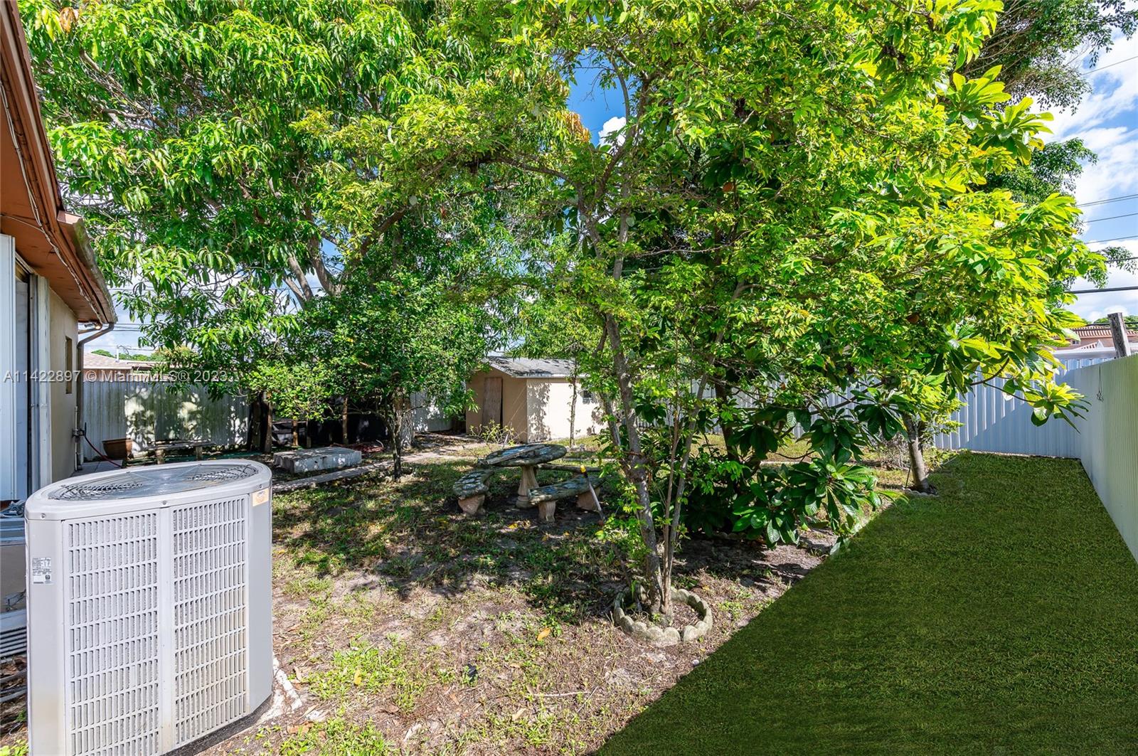 79 West 37th Street Hialeah, FL 33012 - Photo 8 of 28 a backyard of a house with table and chairs