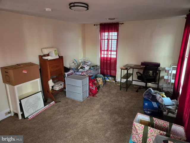 a room with a bed and a dresser