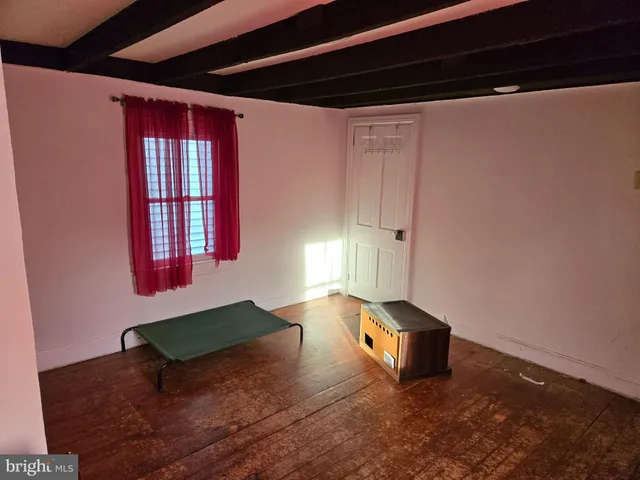 a bedroom with a bed and a mirror