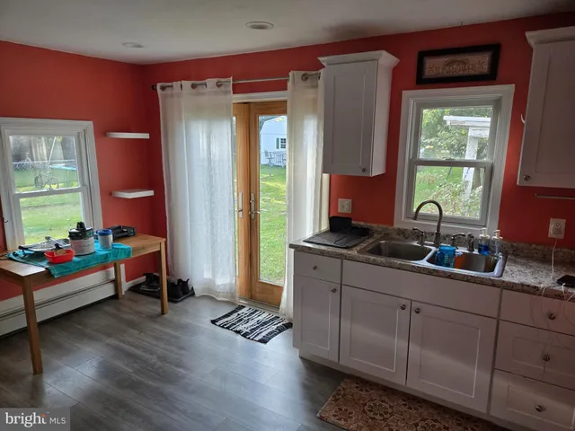 a very nice looking room with wooden floor and furniture