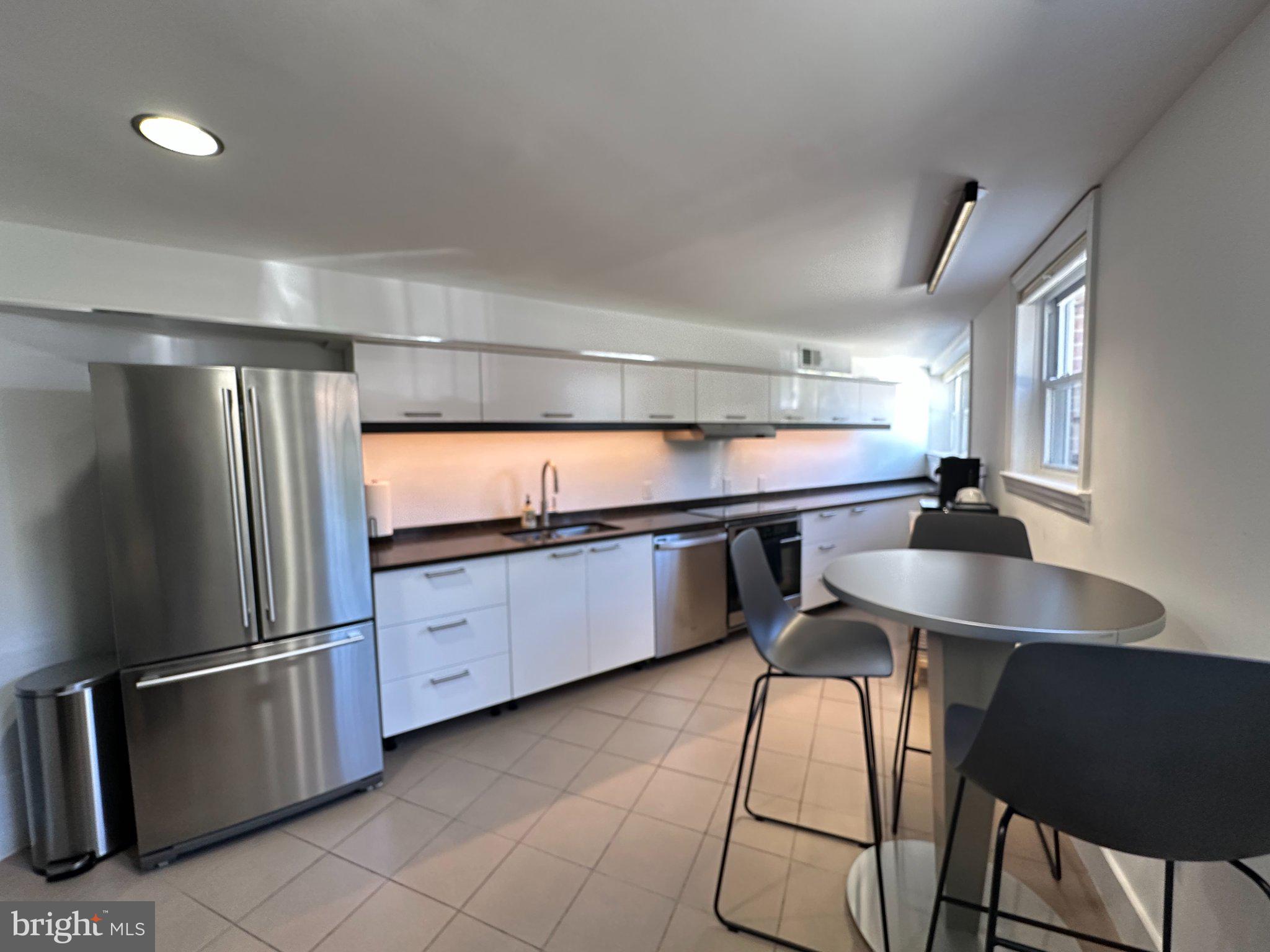 116 Commerce Street Alexandria, VA 22314 - Photo 31 of 50 Sleek modern kitchen with natural light.
