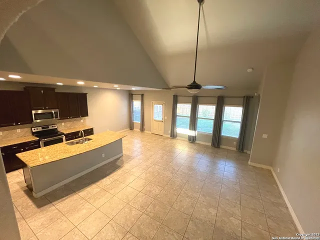 a view of kitchen with furniture and large window