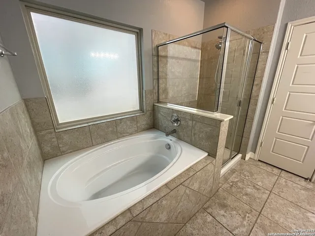 a bathroom with a bathtub and a shower