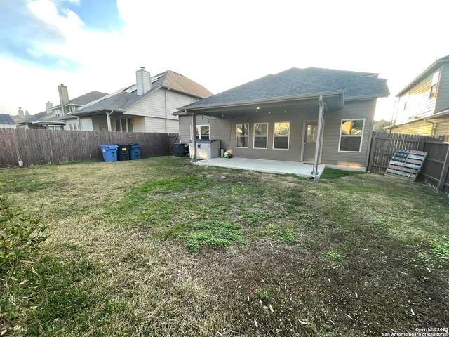 a view of a house with a big yard and large trees
