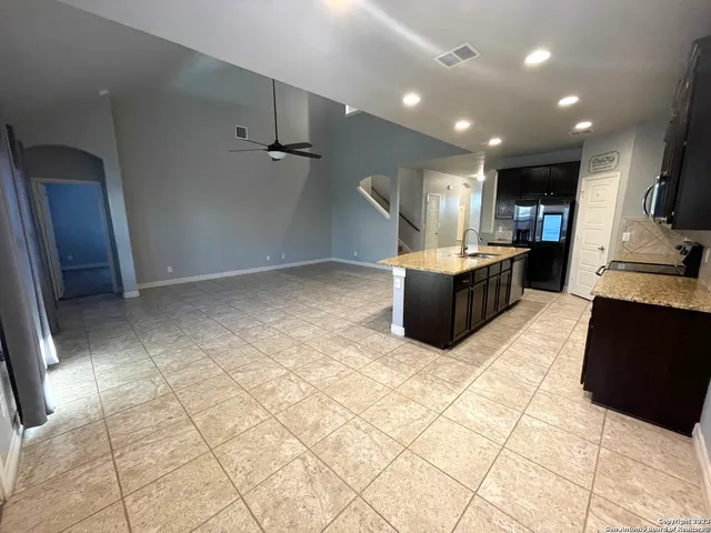 a view of kitchen with furniture and a refrigerator
