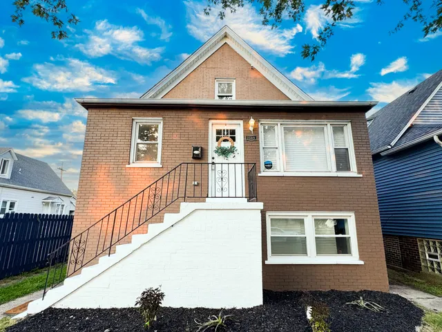 a front view of a house with wooden fence