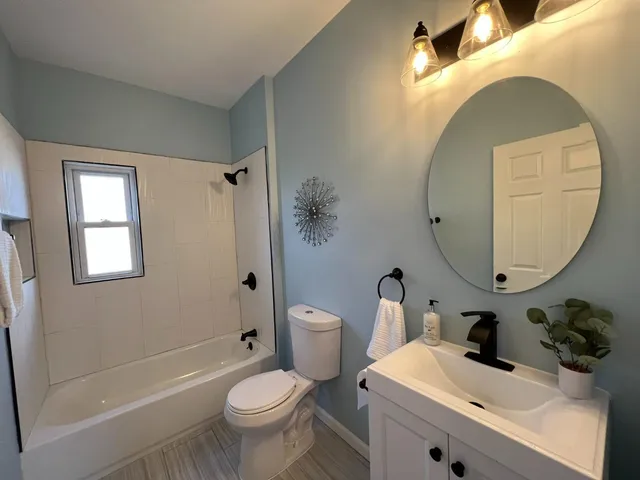 a bathroom with a sink toilet and shower