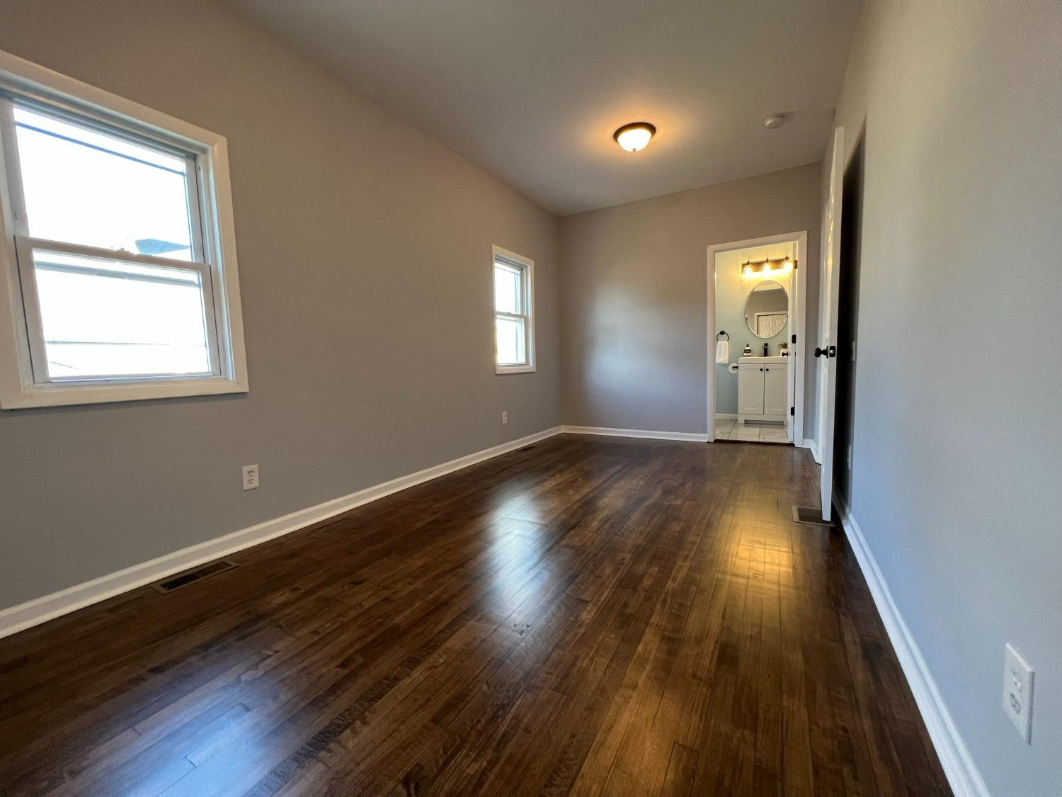 1509 Myrtle Avenue Whiting, IN 46394 - Photo 13 of 26 an empty room with wooden floor and windows