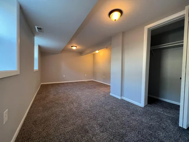 a bathroom with a sink a toilet a mirror and shower