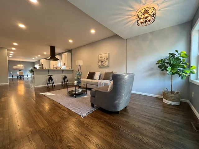 a living room with furniture and a potted plant