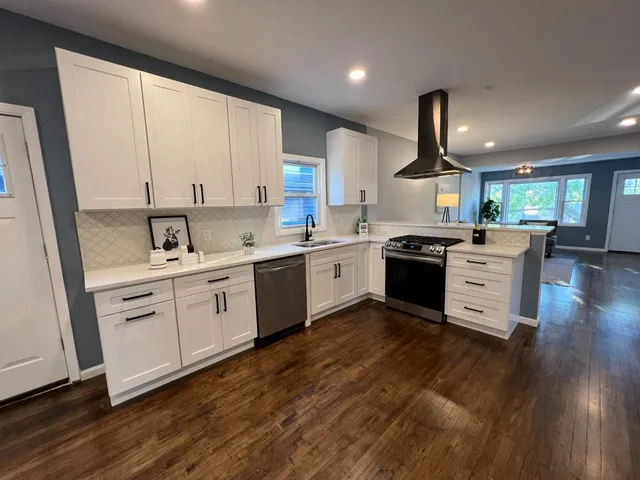 a kitchen with a sink window and cabinets