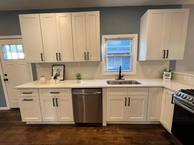 a kitchen with stainless steel appliances granite countertop a sink stove and cabinets