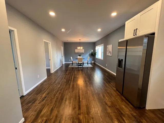 a view of a refrigerator in kitchen and wooden floor