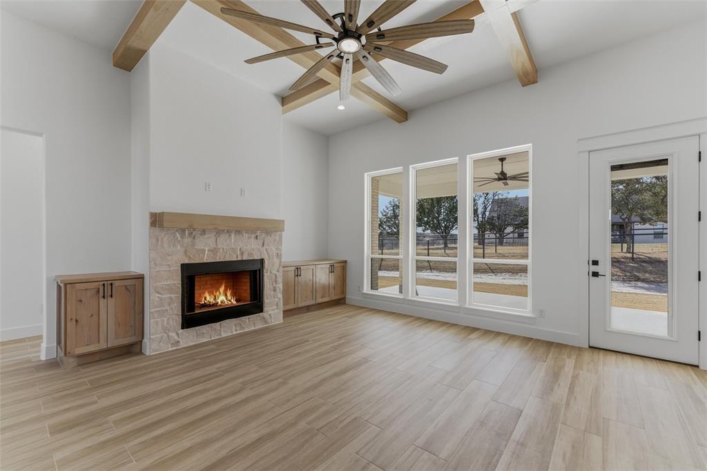 1038 Deer Island Azle, TX 76020 - Photo 11 of 32 a view of an empty room with a fireplace and a window