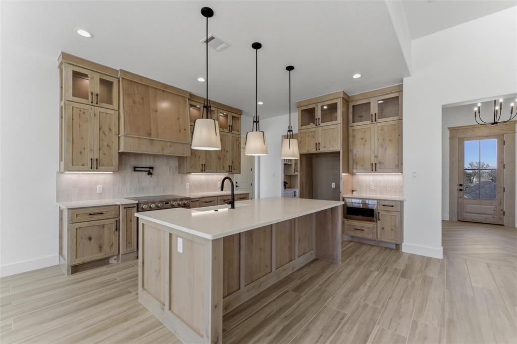 1038 Deer Island Azle, TX 76020 - Photo 12 of 32 a kitchen with stainless steel appliances granite countertop a sink a stove and a wooden floors