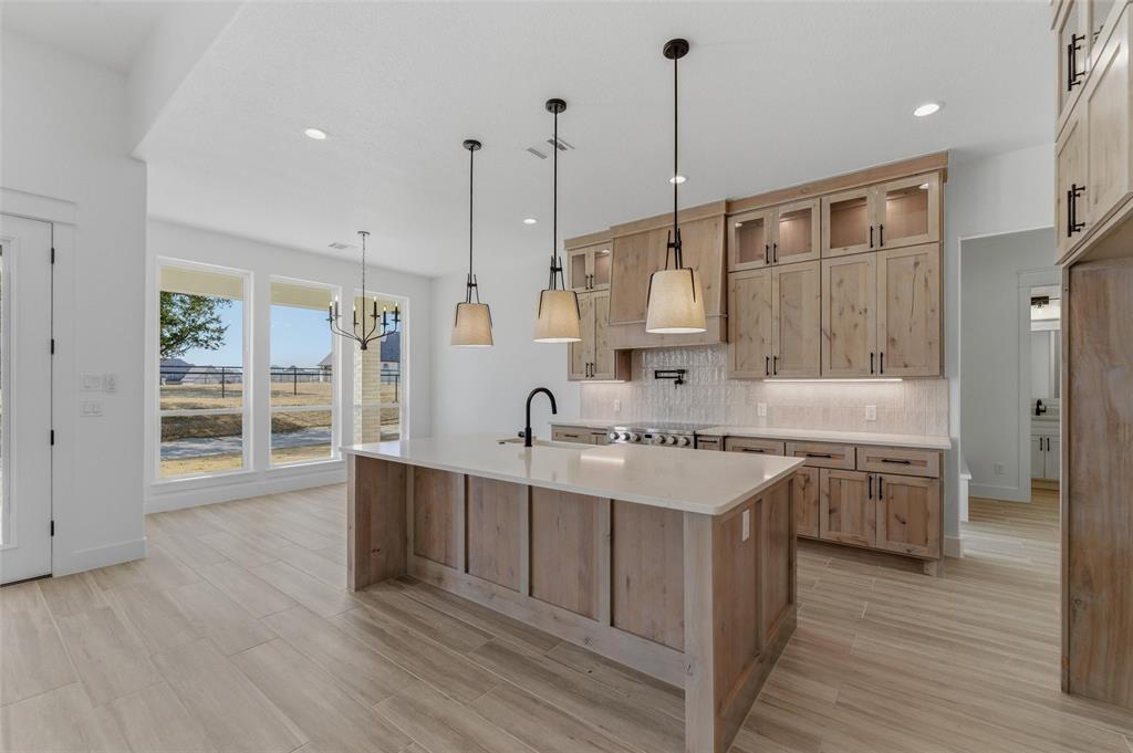 1038 Deer Island Azle, TX 76020 - Photo 13 of 32 a kitchen with a sink stove and wooden cabinets
