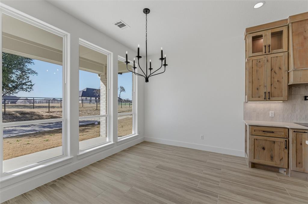 1038 Deer Island Azle, TX 76020 - Photo 14 of 32 a view of a livingroom with wooden floor and a ceiling fan