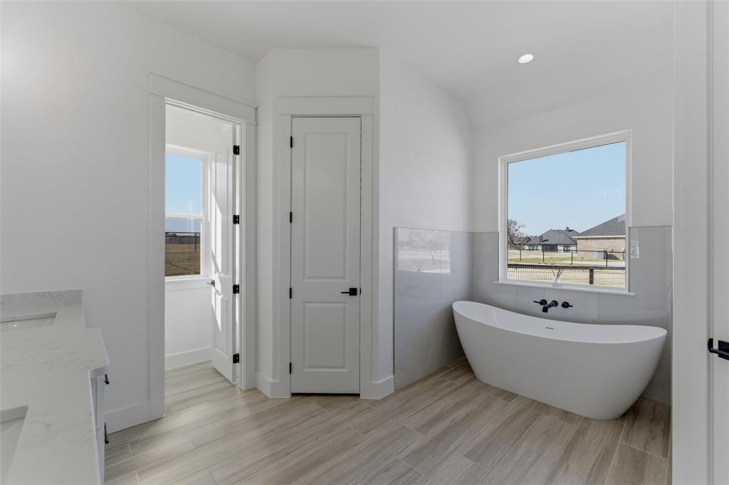 1038 Deer Island Azle, TX 76020 - Photo 18 of 32 a bathroom with a bathtub and shower