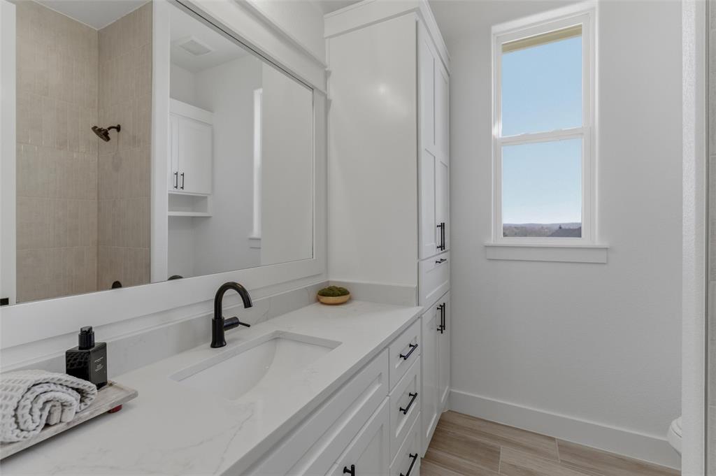 1038 Deer Island Azle, TX 76020 - Photo 22 of 32 a bathroom with a sink and a mirror