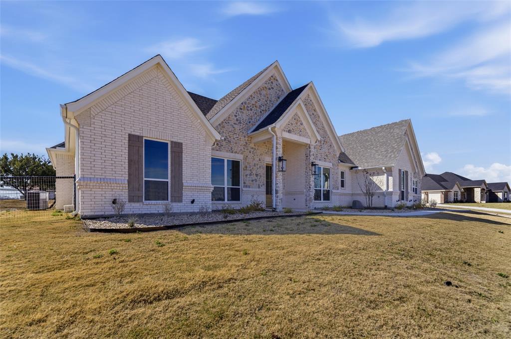 1038 Deer Island Azle, TX 76020 - Photo 5 of 32 a view of a house with a big yard and large tree