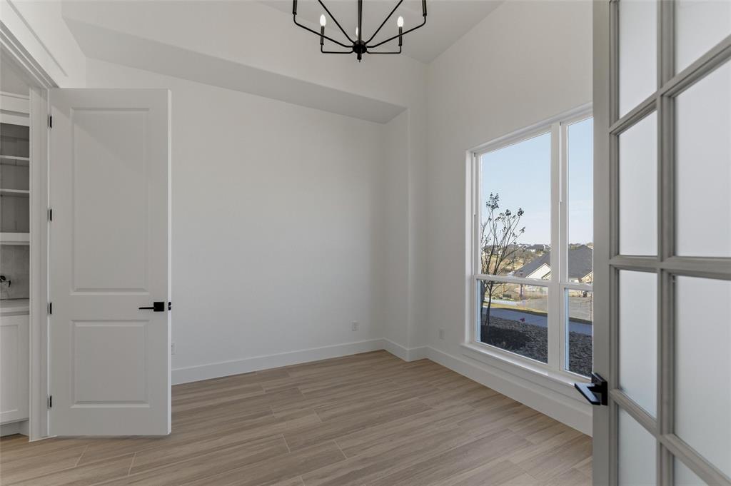 1038 Deer Island Azle, TX 76020 - Photo 9 of 32 a view of empty room with wooden floor and fan