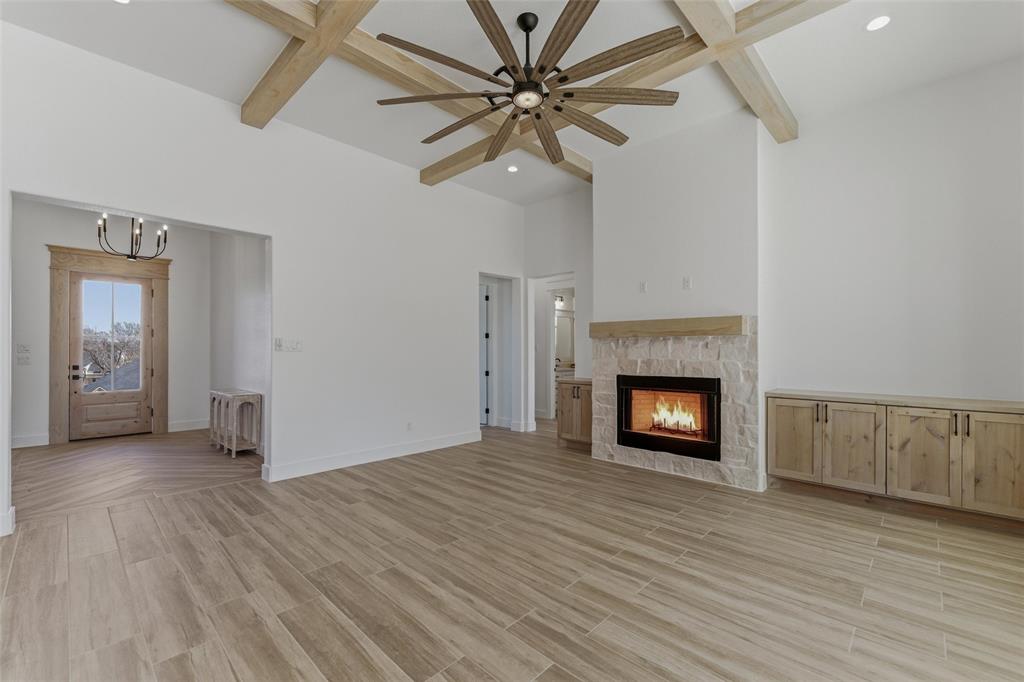 1038 Deer Island Azle, TX 76020 - Photo 10 of 32 an empty room with a fireplace and wooden floor