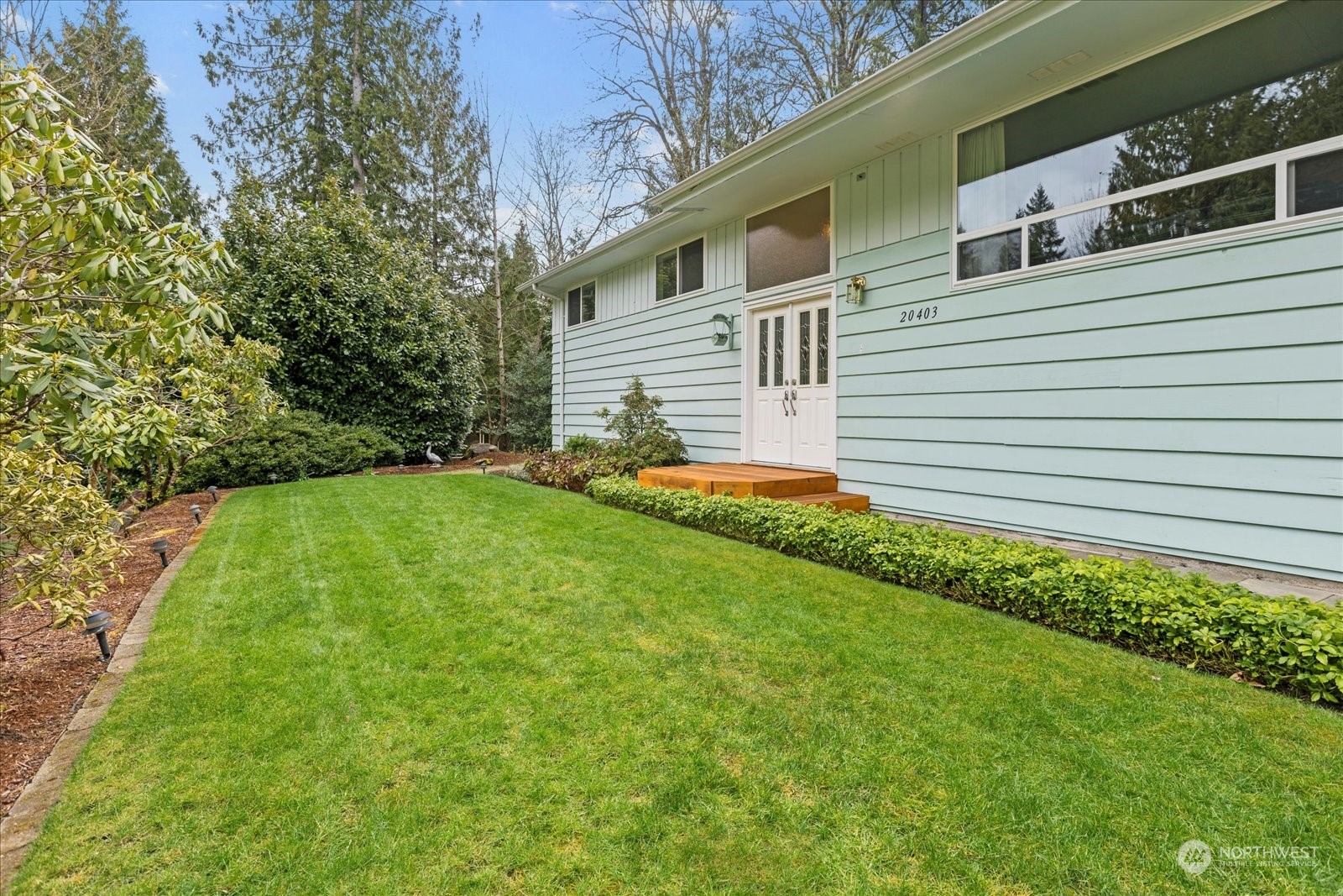 20403 Southeast 145th Street Renton, WA 98059 - Photo 3 of 39 a front view of a house with a yard