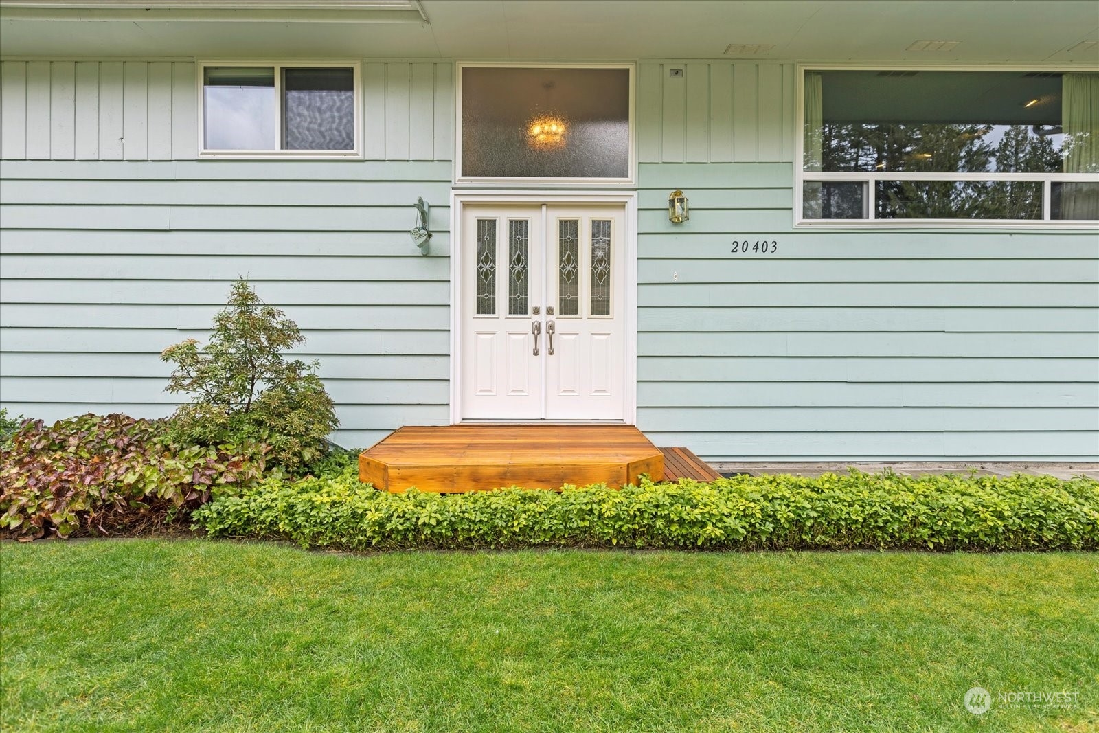 20403 Southeast 145th Street Renton, WA 98059 - Photo 4 of 39 a front view of a house with a yard and garage