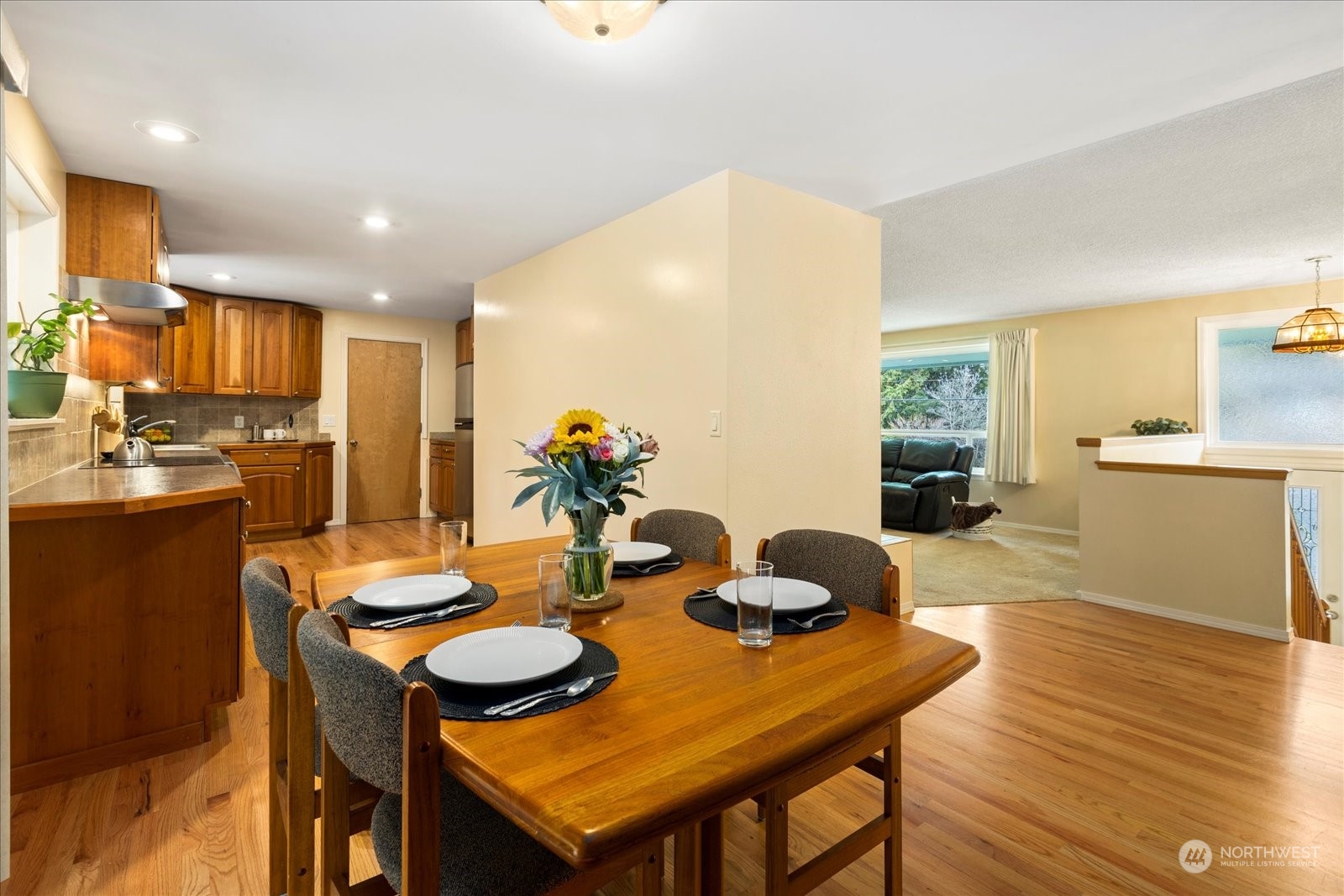 20403 Southeast 145th Street Renton, WA 98059 - Photo 9 of 39 a view of a dining room with furniture and wooden floor