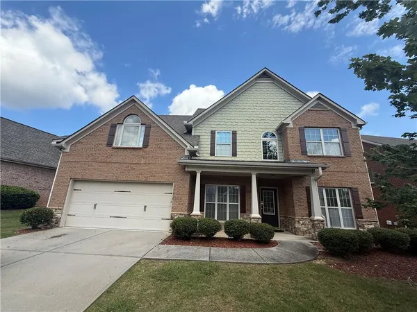 a front view of a house with a yard and garage