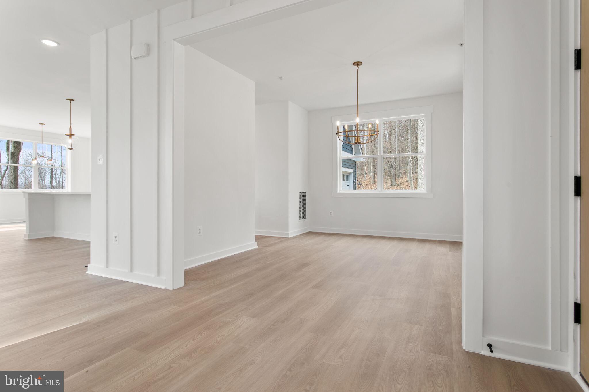 6512 Shady Side Road Shady Side, MD 20764 - Photo 13 of 29 a view of an empty room with wooden floor and a window
