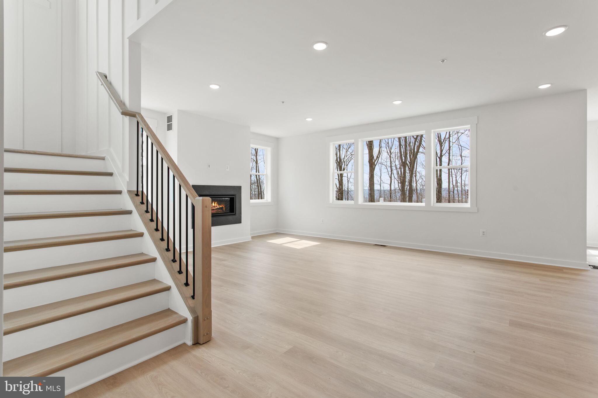 6512 Shady Side Road Shady Side, MD 20764 - Photo 14 of 29 a view of an empty room with wooden floor and stairs