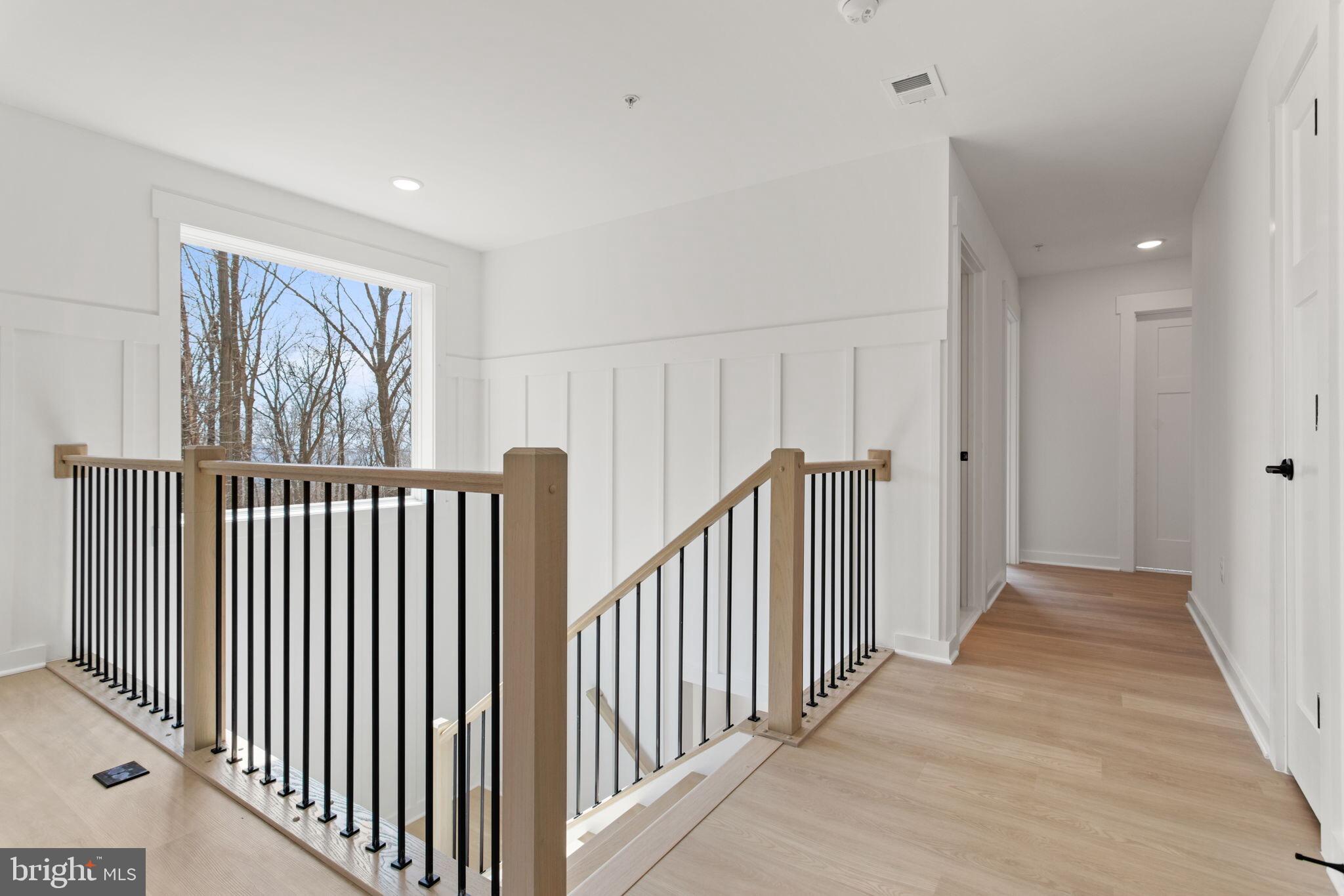 6512 Shady Side Road Shady Side, MD 20764 - Photo 16 of 29 a view of a hallway with wooden floor and windows