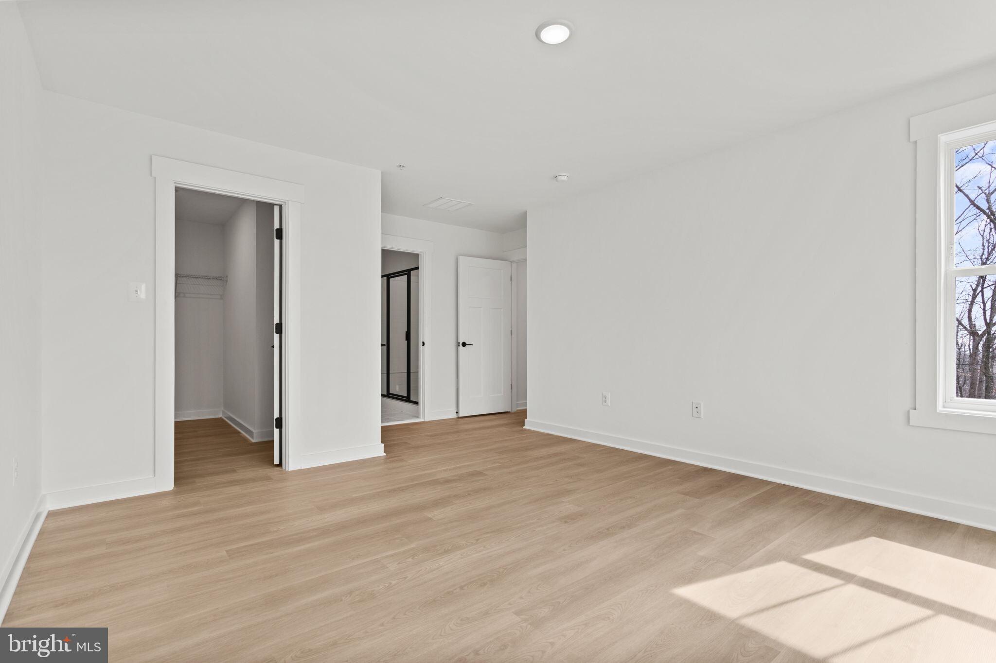 6512 Shady Side Road Shady Side, MD 20764 - Photo 22 of 29 a view of an empty room with wooden floor and a window