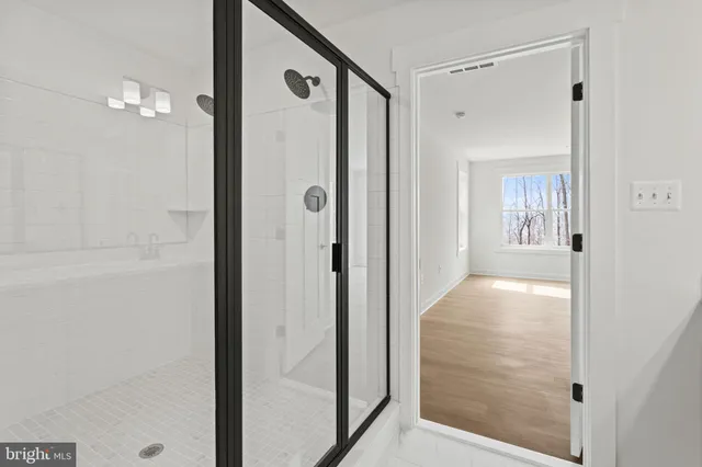 a dining room with furniture a chandelier and wooden floor