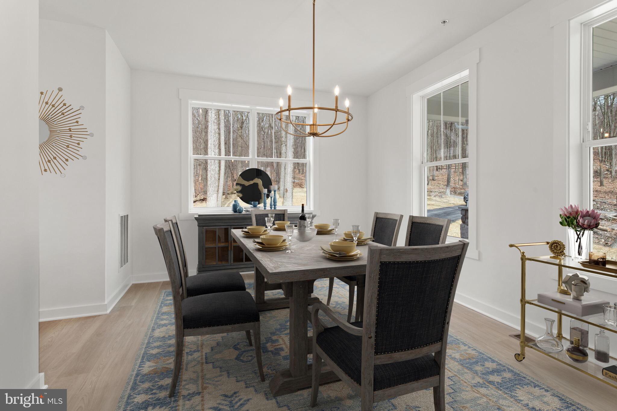 6512 Shady Side Road Shady Side, MD 20764 - Photo 26 of 29 a dining room with furniture a chandelier and wooden floor
