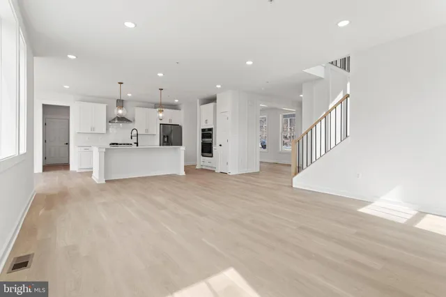 a view of kitchen and kitchen with granite countertop cabinets