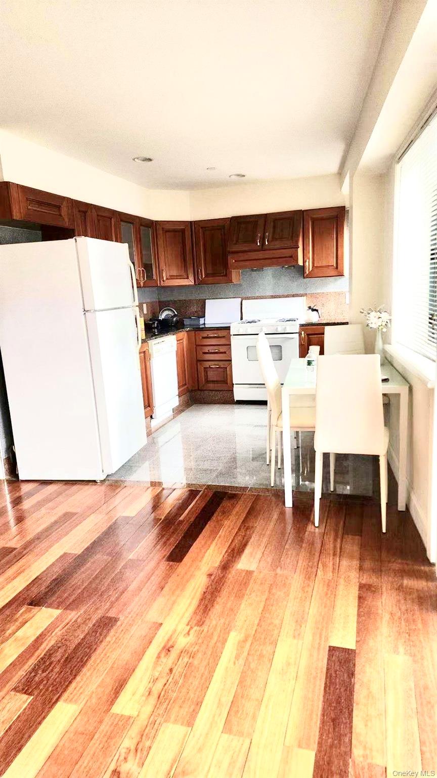 43-18 Main Street, Unit 7F Queens, NY 11355 - Photo 3 of 11 a living room with stainless steel appliances furniture and a table