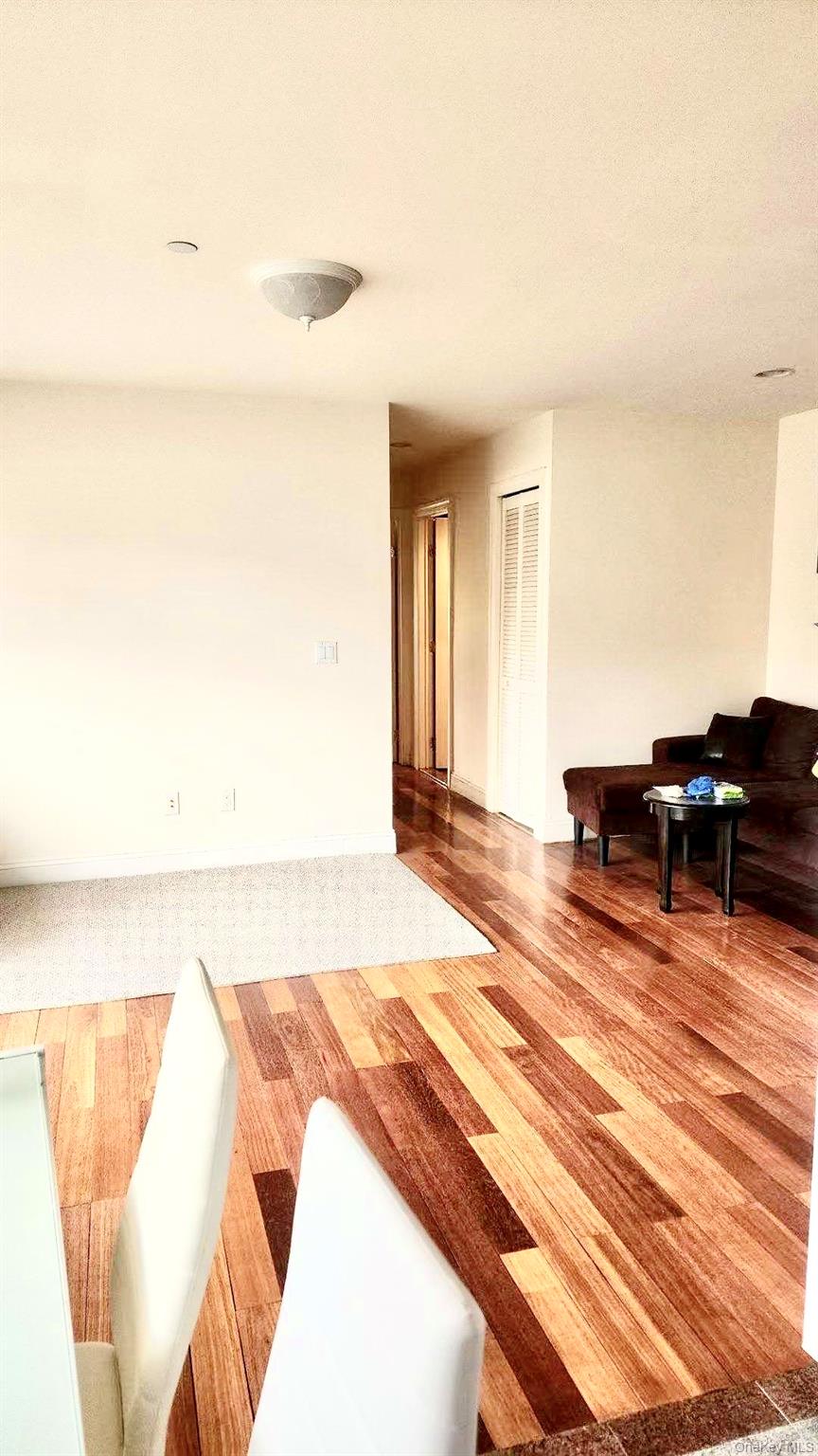 43-18 Main Street, Unit 7F Queens, NY 11355 - Photo 4 of 11 a living room with furniture and a wooden floor