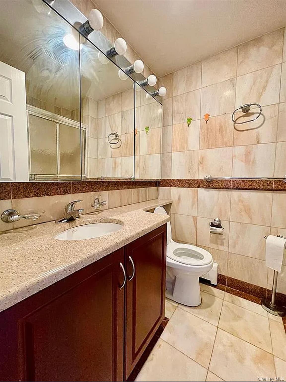 43-18 Main Street, Unit 7F Queens, NY 11355 - Photo 8 of 11 a bathroom with a sink and a mirror