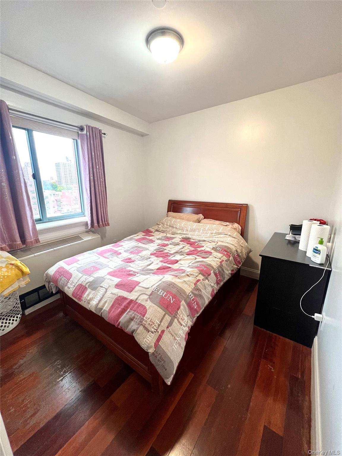 43-18 Main Street, Unit 7F Queens, NY 11355 - Photo 9 of 11 a bedroom with a bed and a window